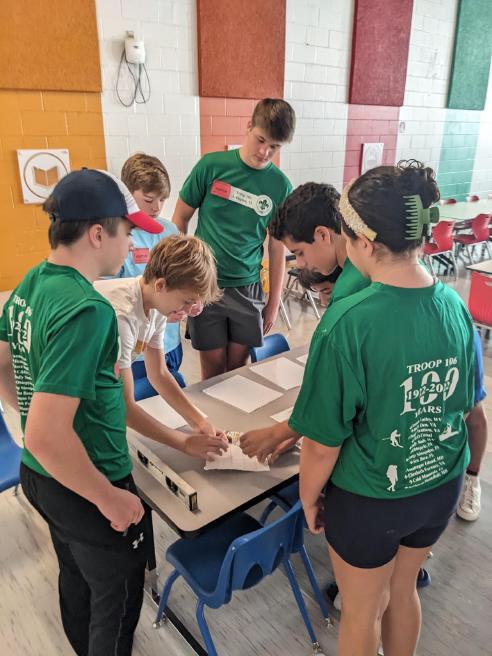 Eagle Scounts setting up multilingual signs