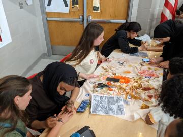 Henna being placed on childrens' hands at International Night