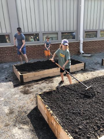 Volunteers placing mulch in the Abingdon Garden beds