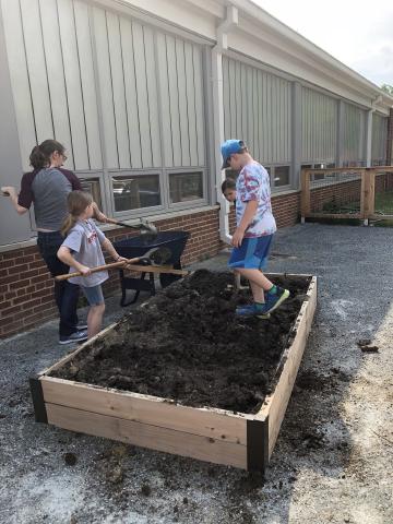 Volunteers placing mulch in the Abingdon Garden beds