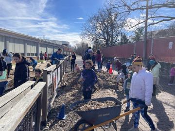 Volunteers carrying woodchips into the garden