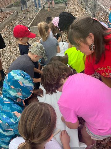 Volunteers making beads out of clay