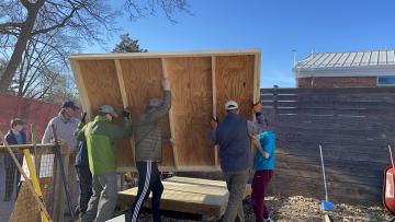Volunteers building a garden shed