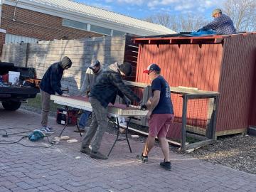 Volunteers building a garden shed