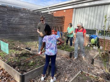 Volunteers cleaning up garden beds