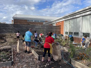 Volunteers cleaning up garden beds