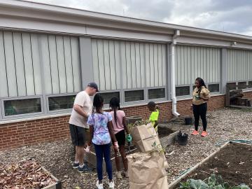 Volunteers cleaning up garden beds